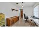 Neutral toned office area, featuring a desk, chair, shelving, and door to another room at 2829 Aloma Ave, Winter Park, FL 32792
