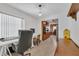 Bright office with a view of the kitchen and a window with blinds at 2829 Aloma Ave, Winter Park, FL 32792