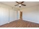 Bedroom with wood floors, closet, ceiling fan, and view into walk-in closet at 1000 Lake Of The Woods Blvd # 103H, Casselberry, FL 32730