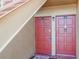 Close-up of front doors with vibrant red paint, unit numbers, and secure lock systems at 1000 Lake Of The Woods Blvd # 103H, Casselberry, FL 32730
