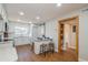 Bright kitchen area with stainless appliances, counter seating and a charming pantry door with wooden frame at 1000 Lake Of The Woods Blvd # 103H, Casselberry, FL 32730