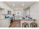 Bright kitchen with stainless appliances, granite counters, barstool seating, and charming accents for modern living at 1000 Lake Of The Woods Blvd # 103H, Casselberry, FL 32730