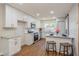Updated kitchen with white cabinets, granite countertops, stainless appliances and cozy barstool seating at 1000 Lake Of The Woods Blvd # 103H, Casselberry, FL 32730