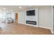 Open living room showcasing an accent wall with TV and fireplace, with a kitchen and doorway nearby at 1000 Lake Of The Woods Blvd # 103H, Casselberry, FL 32730