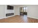 Modern living room featuring a TV, fireplace, wood floors, and sliding glass doors to porch at 1000 Lake Of The Woods Blvd # 103H, Casselberry, FL 32730
