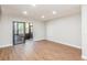 Spacious living room with wood floors and sliding doors leading to the outdoors at 1000 Lake Of The Woods Blvd # 103H, Casselberry, FL 32730