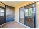 Enclosed patio with outdoor access and sliding glass doors into the living room at 1000 Lake Of The Woods Blvd # 103H, Casselberry, FL 32730