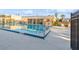 Community swimming pool with lounge chairs, and a building with covered area, ideal for relaxation and recreation at 1000 Lake Of The Woods Blvd # 103H, Casselberry, FL 32730