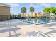 Community pool with clear water, palm trees, and lounge chairs, offering a perfect spot for relaxation and leisure at 1000 Lake Of The Woods Blvd # 103H, Casselberry, FL 32730
