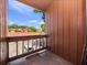 Balcony view showcasing the wood railing and the community and street beyond at 1092 E Michigan St # 1, Orlando, FL 32806