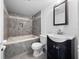 Stylish bathroom features tiled shower and tub, modern vanity, and updated fixtures at 1092 E Michigan St # 1, Orlando, FL 32806