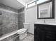 Updated bathroom includes a tiled walk-in shower and modern vanity with dark wood cabinetry at 1092 E Michigan St # 1, Orlando, FL 32806