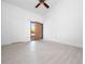Bright bedroom featuring vaulted ceiling, door to balcony, and modern light wood-look flooring at 1092 E Michigan St # 1, Orlando, FL 32806