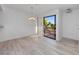 Bright dining area with sliding glass door opens to a balcony with wooded views at 1092 E Michigan St # 1, Orlando, FL 32806