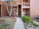 Inviting condo exterior featuring a walkway and lush landscaping with a well-maintained facade at 1092 E Michigan St # 1, Orlando, FL 32806