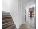 Hallway with stairs and new flooring leading to a bright living area with ample closet space at 1092 E Michigan St # 1, Orlando, FL 32806