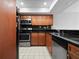 Well-equipped kitchen features stainless steel appliances, dark countertops, and wooden cabinetry at 1092 E Michigan St # 1, Orlando, FL 32806