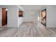 Bright living area with wood-look flooring, modern light fixture, and sliding glass doors at 1092 E Michigan St # 1, Orlando, FL 32806