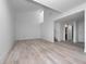 Open living room with new flooring, offering plenty of space with a view of the staircase at 1092 E Michigan St # 1, Orlando, FL 32806