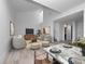 Bright open-concept living area with modern decor, light floors, and access to dining at 1092 E Michigan St # 1, Orlando, FL 32806