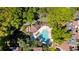 A luxury pool and seating area with a pergola is surrounded by mature landscaping at 1092 E Michigan St # 1, Orlando, FL 32806