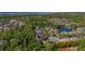 Aerial view of a neighborhood with lake views and mature trees in a desirable location at 115 Ellington Pl, Oviedo, FL 32765