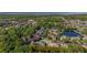 Panoramic aerial view of a neighborhood featuring lake views and mature trees in a desirable location at 115 Ellington Pl, Oviedo, FL 32765
