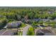 Aerial view of a luxurious home nestled in a lush, green neighborhood at 115 Ellington Pl, Oviedo, FL 32765