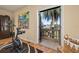 View from an exercise room onto a charming stone balcony with lush greenery beyond at 115 Ellington Pl, Oviedo, FL 32765