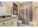 Bathroom featuring a granite countertop, wood blinds, a towel bar, and a shower with a curtain at 115 Ellington Pl, Oviedo, FL 32765