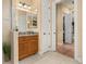 Bathroom featuring granite counter vanity, walk-in shower, and access to the closet at 115 Ellington Pl, Oviedo, FL 32765
