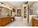 Luxurious bathroom with dual vanities, soaking tub, walk-in shower, and ample storage at 115 Ellington Pl, Oviedo, FL 32765