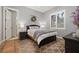 A charming bedroom with natural light, neutral paint, and a patterned rug at 115 Ellington Pl, Oviedo, FL 32765