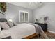 A bright, naturally lit bedroom featuring neutral paint and gray accents at 115 Ellington Pl, Oviedo, FL 32765