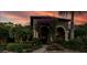 Charming home exterior with lush landscaping, brick walkway, and flowering vines at 115 Ellington Pl, Oviedo, FL 32765