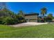 Exterior view showing a driveway, the side of the home, landscaping, and green lawn at 115 Ellington Pl, Oviedo, FL 32765