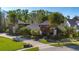 Stunning exterior view of this home with lush landscaping, mature trees, and circular driveway at 115 Ellington Pl, Oviedo, FL 32765