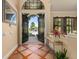 Foyer with open double doors, tiled floors, and view of the front yard with lush landscaping at 115 Ellington Pl, Oviedo, FL 32765