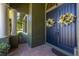 Inviting entryway with double doors, columns, wreaths, and brick flooring at 115 Ellington Pl, Oviedo, FL 32765