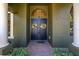 Inviting front entry featuring double doors, decorative wreaths, and classic architectural details at 115 Ellington Pl, Oviedo, FL 32765