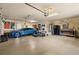 Spacious garage with exercise equipment, epoxy floor, a car, and a beer pong table at 115 Ellington Pl, Oviedo, FL 32765