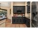 Gourmet kitchen with dark cabinetry, granite countertops, wine rack, and stainless steel appliances at 115 Ellington Pl, Oviedo, FL 32765