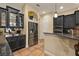 Kitchen features stainless steel appliances, dark cabinets, granite countertops, and tiled floors at 115 Ellington Pl, Oviedo, FL 32765