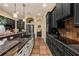 A spacious kitchen with stainless steel appliances, dark cabinetry, and a peninsula counter with a sink at 115 Ellington Pl, Oviedo, FL 32765