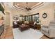The living room features a ceiling fan, an elegant fireplace, and a leather sofa at 115 Ellington Pl, Oviedo, FL 32765