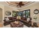 Cozy living room features a view of the outdoor lanai and an adjacent fireplace at 115 Ellington Pl, Oviedo, FL 32765