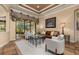 Comfortable living room with glass doors that open to the lanai, plush seating, and stylish decor at 115 Ellington Pl, Oviedo, FL 32765