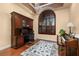 Bright office features a large arch window with plantation shutters and beautiful wood floors and trim at 115 Ellington Pl, Oviedo, FL 32765