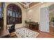 Well-appointed office with a large arched window, plantation shutters, and hardwood floors at 115 Ellington Pl, Oviedo, FL 32765