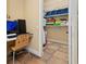 Compact office space including desk, chair, computer, and walk-in closet storage at 115 Ellington Pl, Oviedo, FL 32765